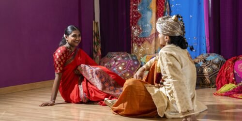 happy-indian-couple-in-traditional-clothes-wedding-event-sitting-on-the-floor-scaled-1.jpg